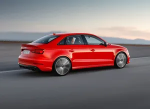 A Sleek White Sedan Car Driving On A Picturesque Highway Wallpaper