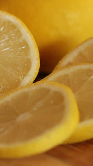 A Slice Of Lemon On A Wooden Cutting Board Wallpaper