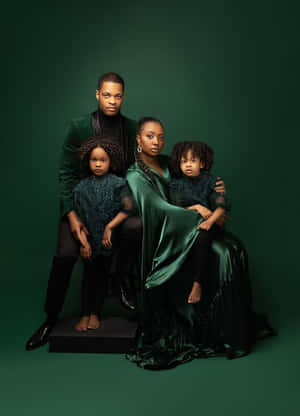 A Smiling Family Of Four In A Cozy Portrait Wallpaper