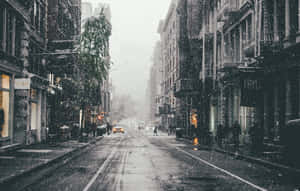 A Snow-covered Icy Road Amidst A Frozen Landscape Wallpaper