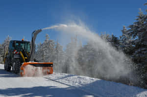 A Snowplow In Action On A Snowy Day Wallpaper