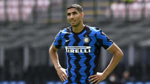 A Soccer Player In A Blue Uniform Standing On A Field Wallpaper