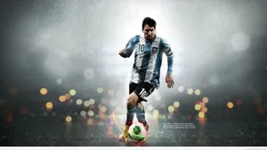 A Soccer Player Is Kicking A Ball In The Rain Wallpaper
