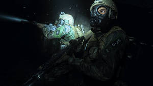 A Soldier In A Gas Mask Is Holding A Gun Wallpaper