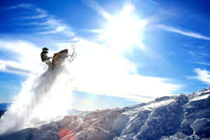 A Solitary Winter Climber On Snowy Slopes Wallpaper