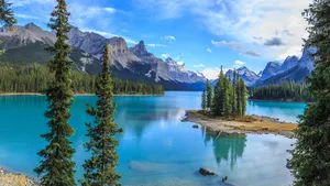 A Spectacular, Panoramic View Of A Mountain In The Mist, Surrounded By A Peaceful Lake Wallpaper