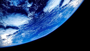 A Spiraling Swirl Of Blue, White And Green - Earth As Seen From Space Wallpaper