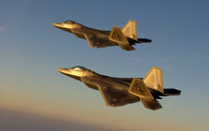 A Squadron Of Us Military Jets Fly In Formation Over A Desert Landscape Wallpaper