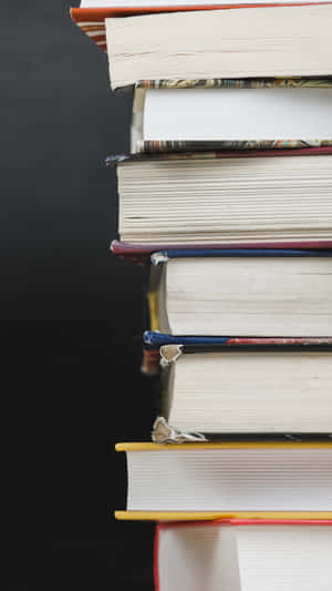 A Stack Of Books On A Black Background Wallpaper