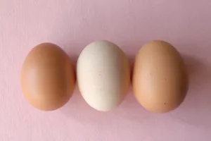 A Stack Of Brown Eggs In A Rustic Kitchen Setting Wallpaper