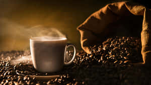 A Steaming Cup Of Freshly Brewed Brown Coffee On A Rustic Wooden Table Wallpaper