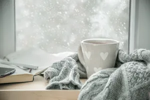 A Steaming Cup Of Hot Chocolate With Floating Marshmallows On Wooden Table Wallpaper