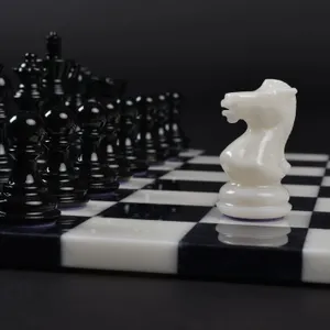 A Strategic Game Of Black And White Chess Pieces On A Beautiful Chessboard Wallpaper