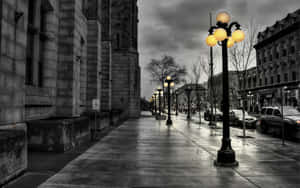 A Street Lamp On A Wet Sidewalk Wallpaper