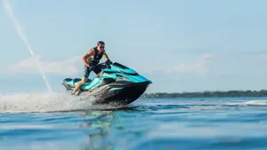A Striking Blue And Black Jet Ski, Gliding Seamlessly Through The Water Wallpaper
