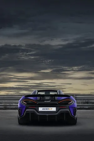 A Striking Mclaren 600lt On The Road Wallpaper