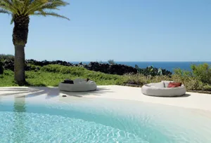 A Stunning Aerial View Of A Beach Swimming Pool By The Ocean Wallpaper