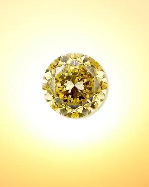 A Stunning And Luxurious Yellow Diamond Shining Brightly Against A Dark Background Wallpaper