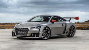 A Stunning Audi Tt Rs Sports Coupe On The Road Wallpaper