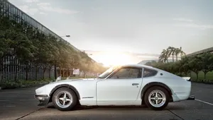 A Stunning Blue Datsun In A Radiant Outdoor Setting Wallpaper