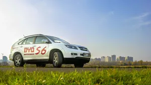 A Stunning Byd Electric Vehicle Parked On A Picturesque Street. Wallpaper