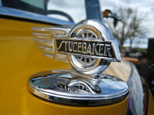 A Stunning Close-up View Of A Car's Hood And Front Grille Wallpaper