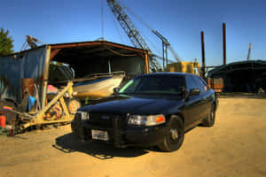 A Stunning Ford Crown Victoria Parked On The Street Wallpaper