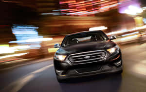 A Stunning Ford Taurus On The Highway Wallpaper