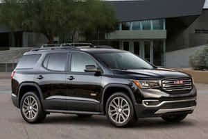 A Stunning Gmc Acadia In A Dynamic Outdoor Setting Wallpaper