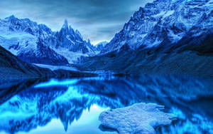 A Stunning Icy Scene Of The Snowy Mountains In Winter Wallpaper