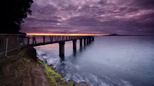 A Stunning Laptop On A Bridge At Twilight Wallpaper