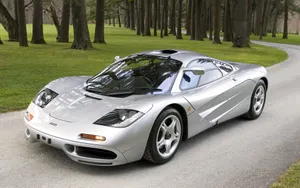A Stunning Mclaren F1 Sports Car Showcased Against A Breathtaking Mountain Backdrop. Wallpaper