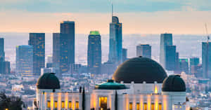 A Stunning Night View Of An Observatory Under The Star-filled Sky Wallpaper