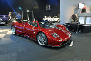 A Stunning Pagani Zonda C12 Roadster In Motion On A Scenic Road Wallpaper