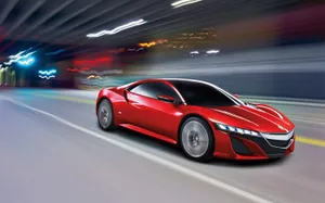 A Stunning Red Acura Nsx Showcased On An Open Road Wallpaper