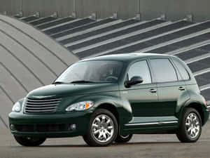 A Stunning Red Chrysler Pt Cruiser Parked Outdoors Wallpaper