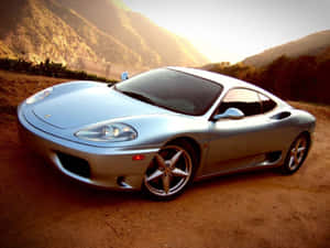 A Stunning Red Ferrari 360 Modena Showcasing Its Elegant Design On An Open Road. Wallpaper