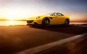 A Stunning Red Ferrari California T Cruising On An Open Road Wallpaper