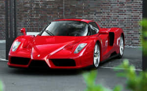 A Stunning Red Ferrari Enzo Showcased In Natural Light Wallpaper