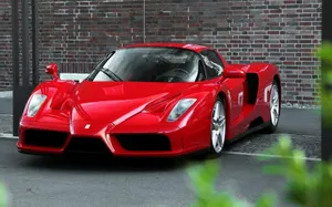 A Stunning Red Ferrari Enzo Showcased In Natural Light Wallpaper