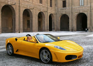 A Stunning Red Ferrari F430 Parked In An Urban Setting. Wallpaper