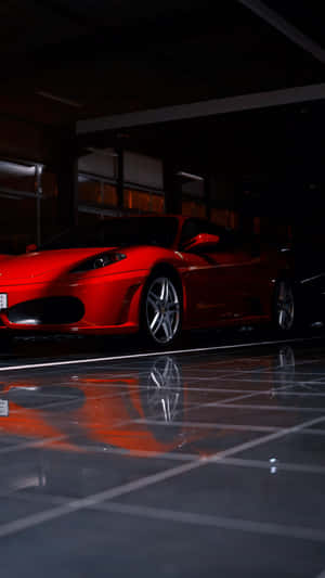 A Stunning Red Ferrari F430 Showcasing Its Sleek Design And Powerful Presence Wallpaper