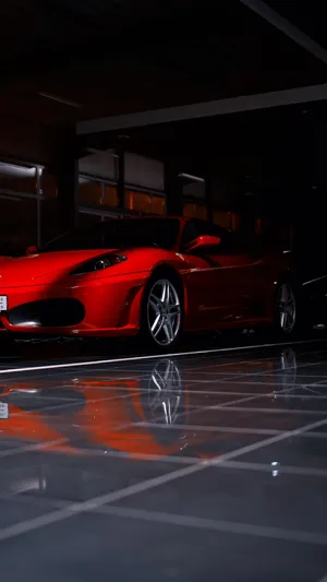 A Stunning Red Ferrari F430 Showcasing Its Sleek Design And Powerful Presence Wallpaper