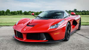 A Stunning Red Ferrari Laferrari On The Road Wallpaper