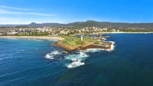 A Stunning Sunset Over The Wollongong Lighthouse Wallpaper