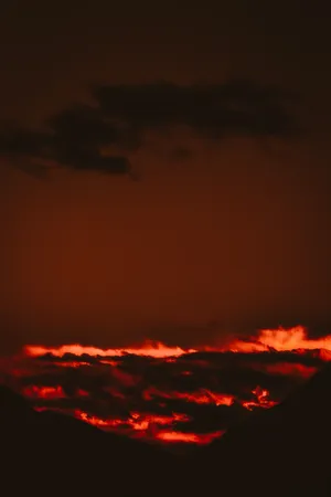 A Stunning View Of Fiery Red Clouds During A Red-orange Sunset. Wallpaper