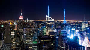 A Stunning View Of The Iconic Skyline Of New York City At Night. Wallpaper