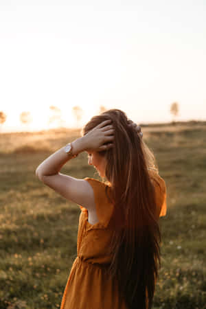 A Stunning Woman Enjoying A Beautiful Day Surrounded By Nature Wallpaper