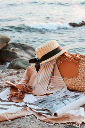 A Stylish Beach Bag On Sunny Shore Wallpaper