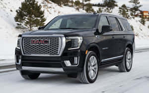 A Stylish Gmc Yukon On The Road Wallpaper